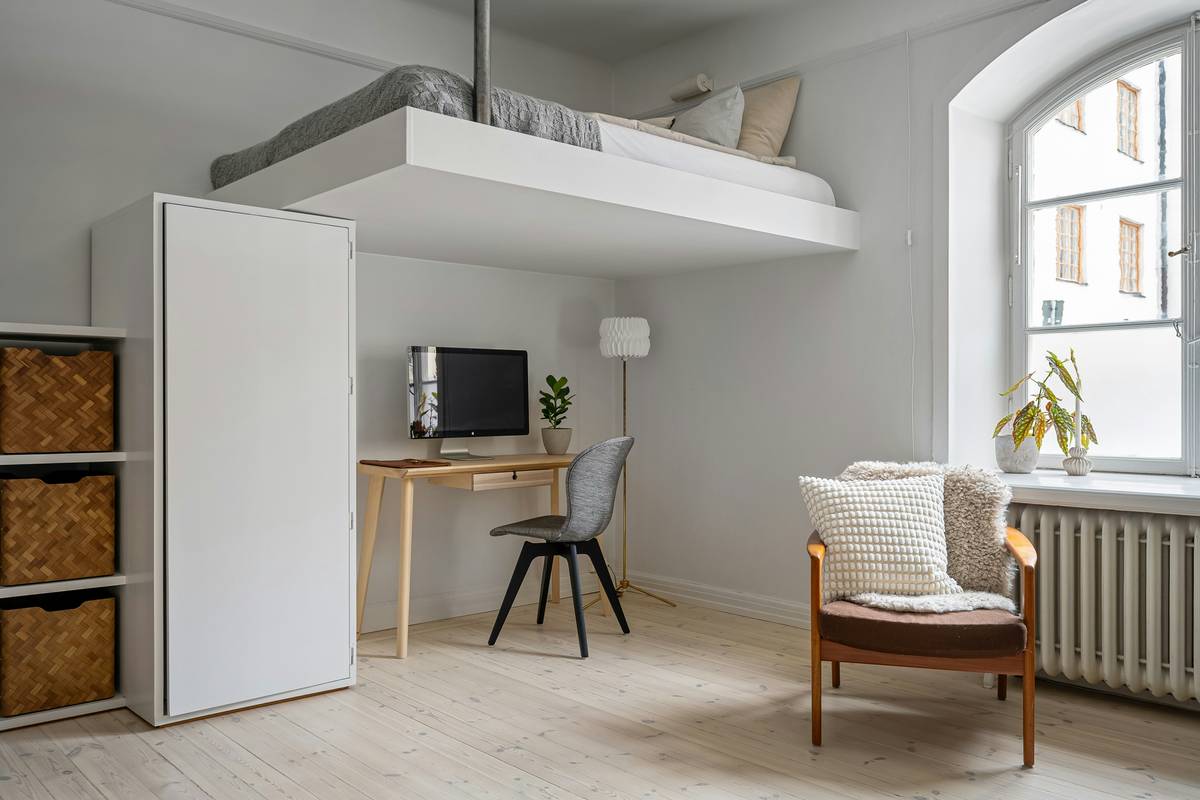 foldable wall desk smart furniture mounted on white wall with laptop, notebook, and coffee cup neatly arranged